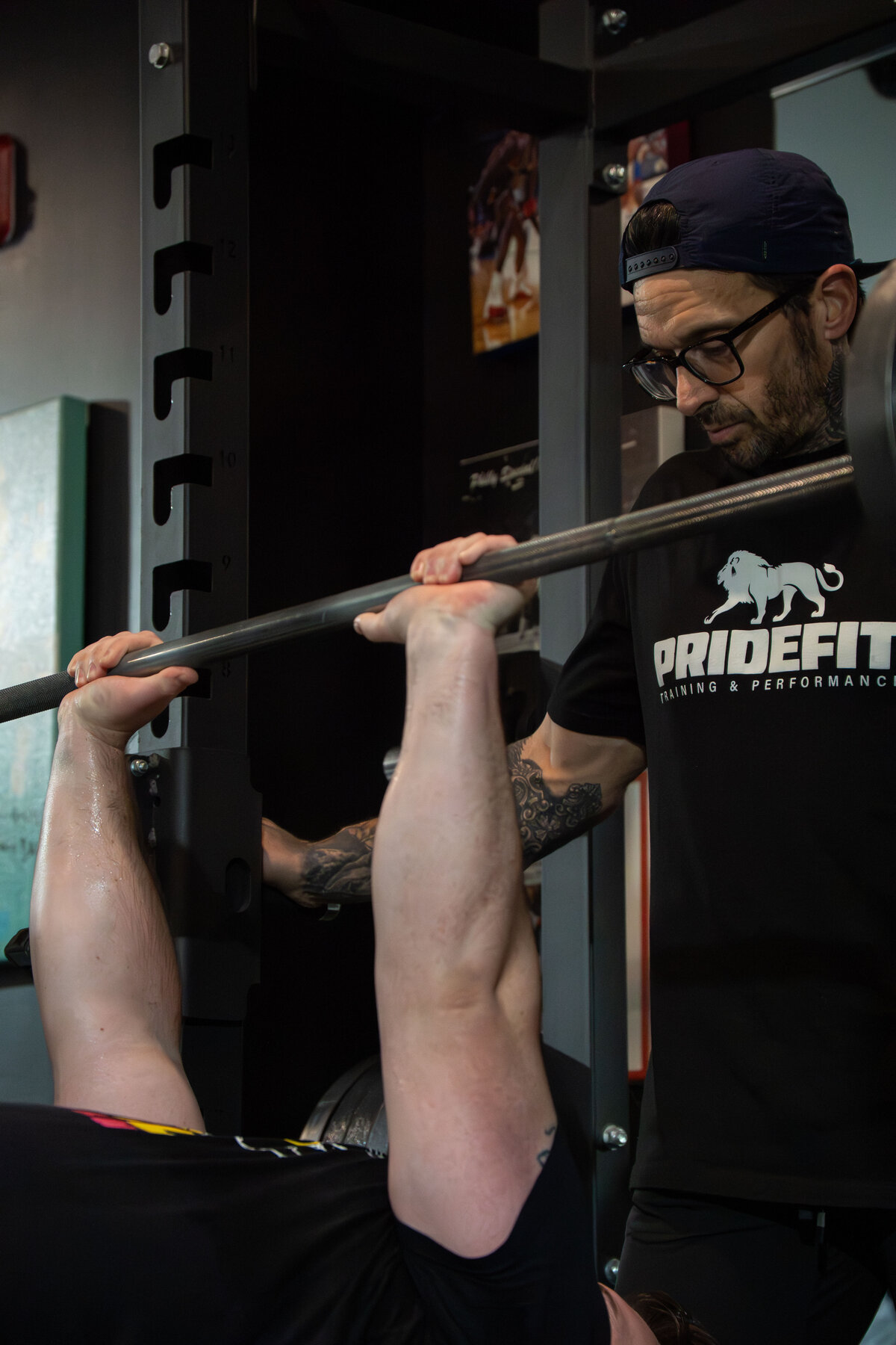 Bench press with PrideFit coach spotting