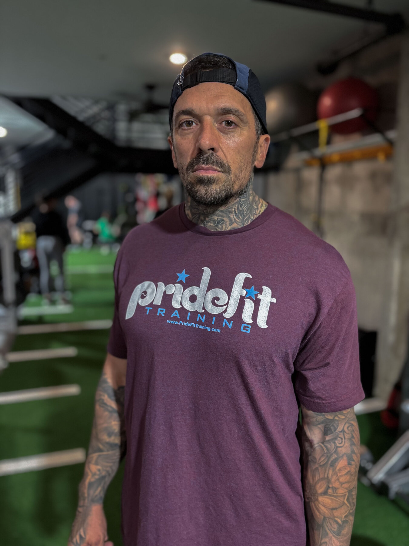 Joe Ferrero coaching a member through a movement assessment at PrideFit
