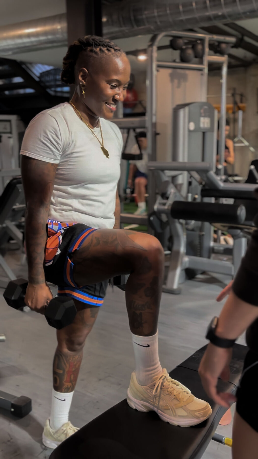 Two members training side-by-side on leg-extension at PrideFit