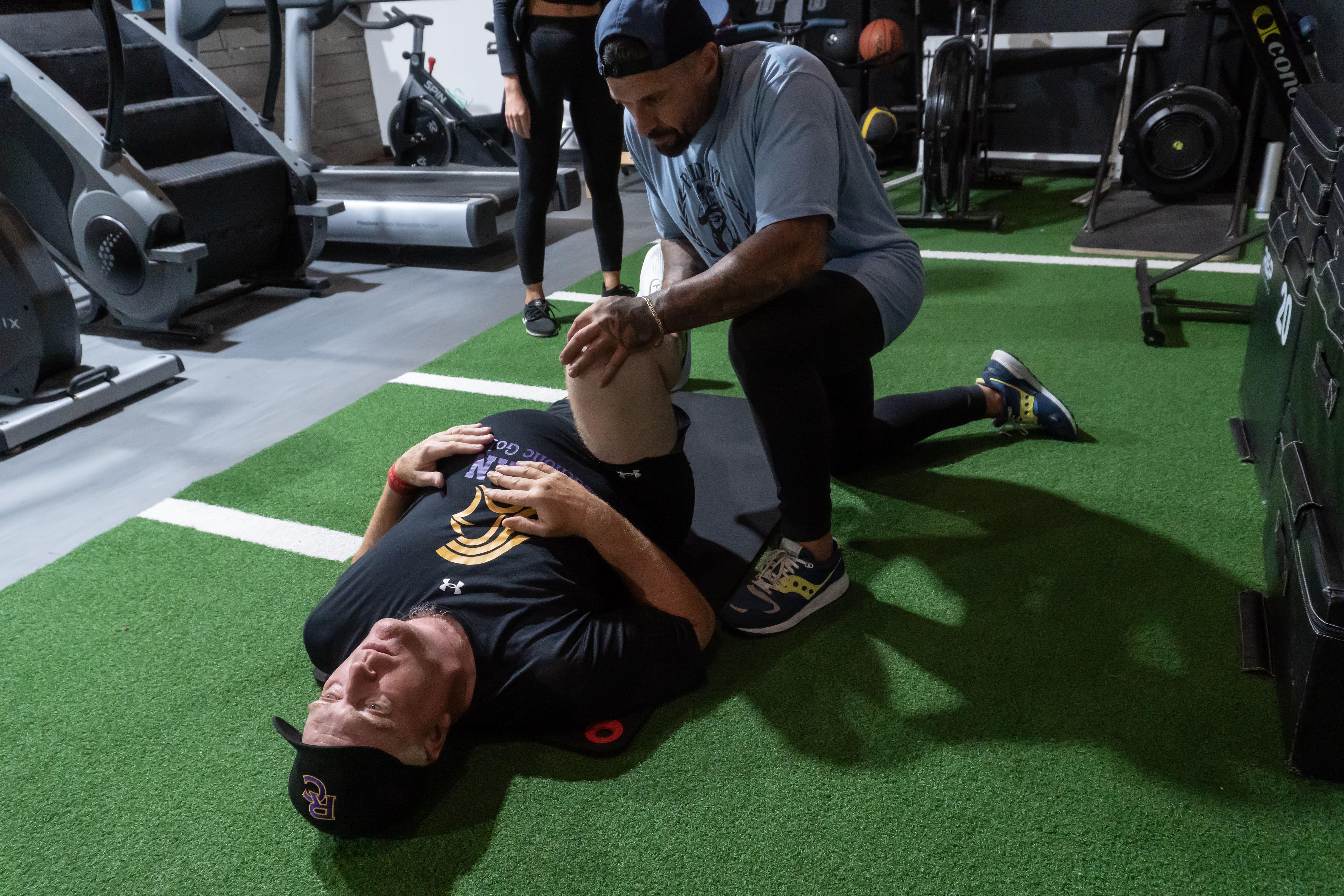 Coach guiding a client through a mobility stretch